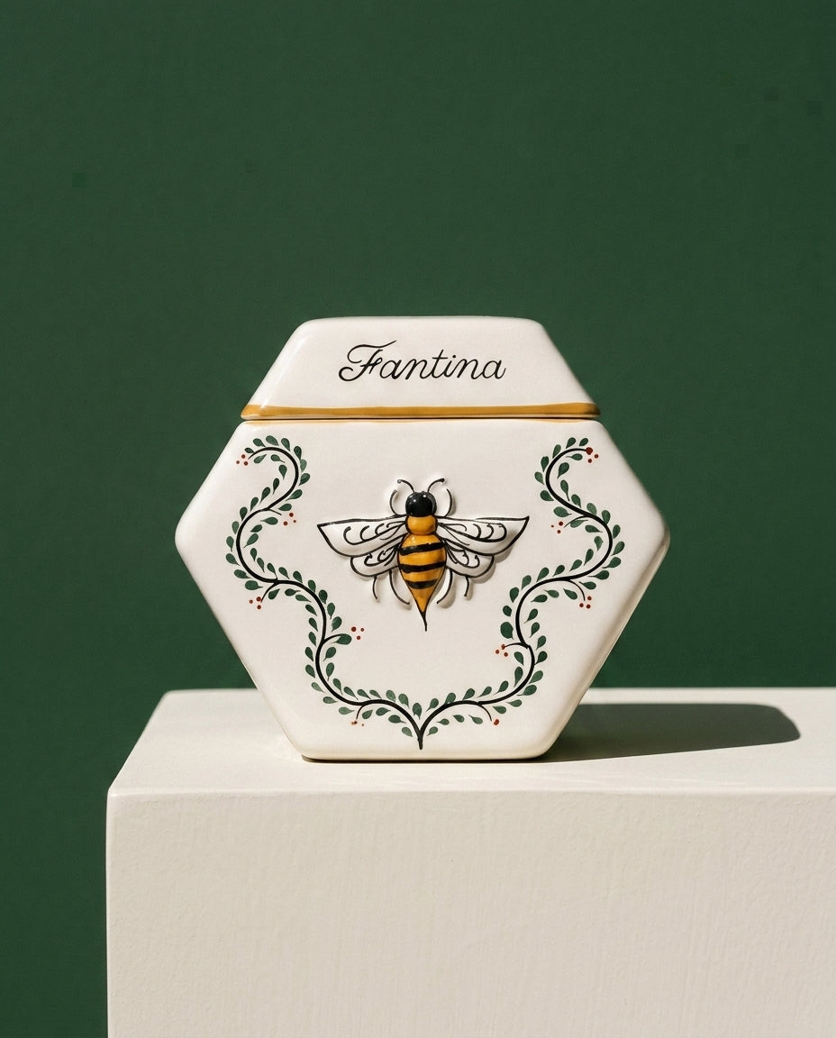 The Enredadera vessel on a bone-white plinth against a deep green wall.